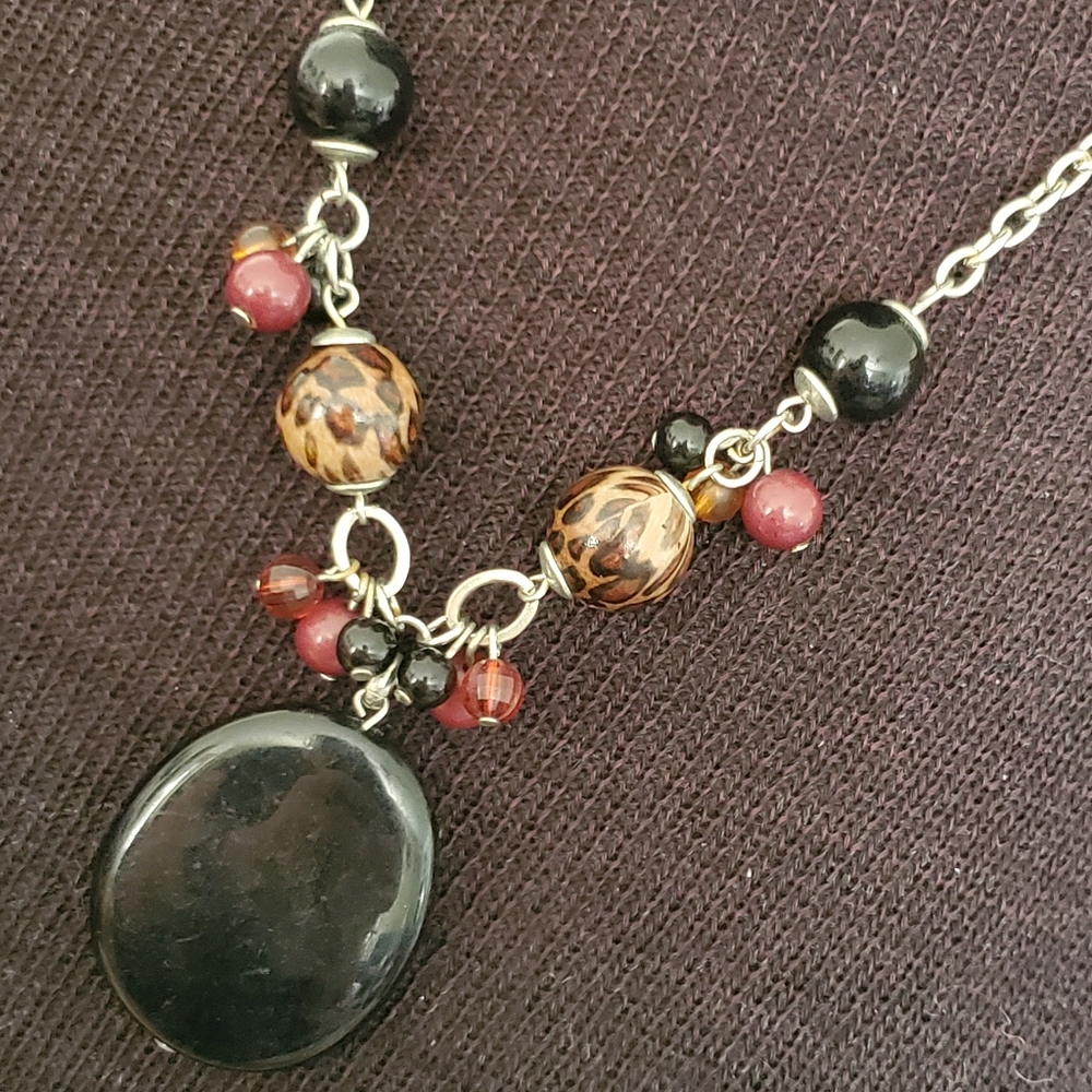 Silvertone necklace with black pendant, leopard print beads